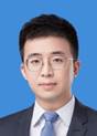A person wearing glasses and a suit
Description automatically generated